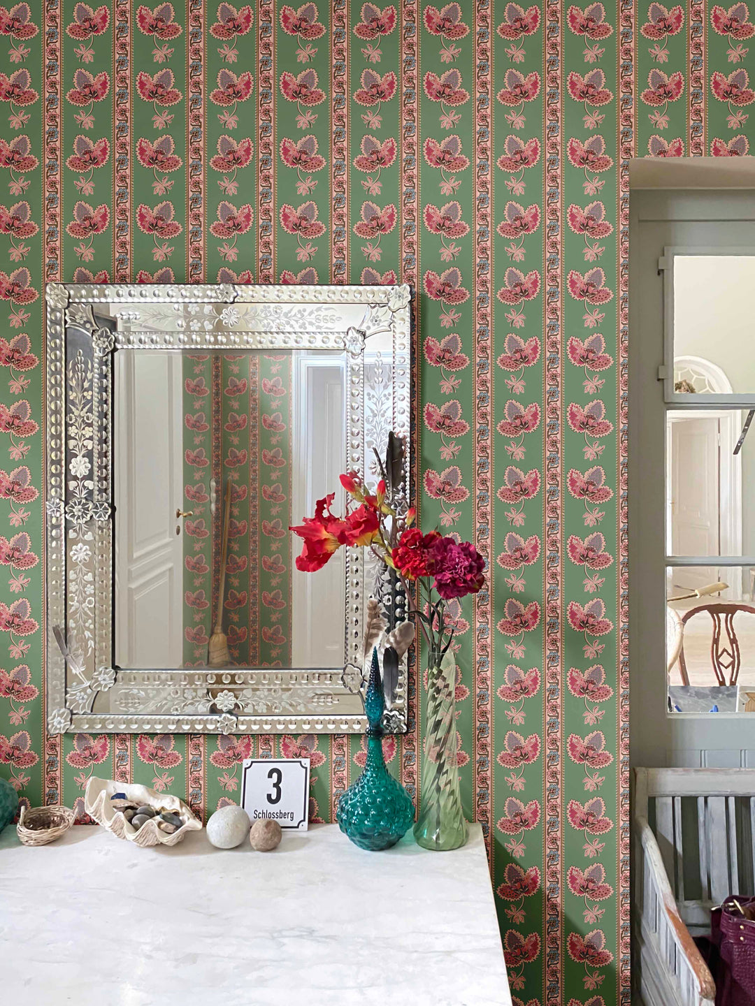 Serafina Stripe is a green floral striped wallpaper shown on the walls of a hallway