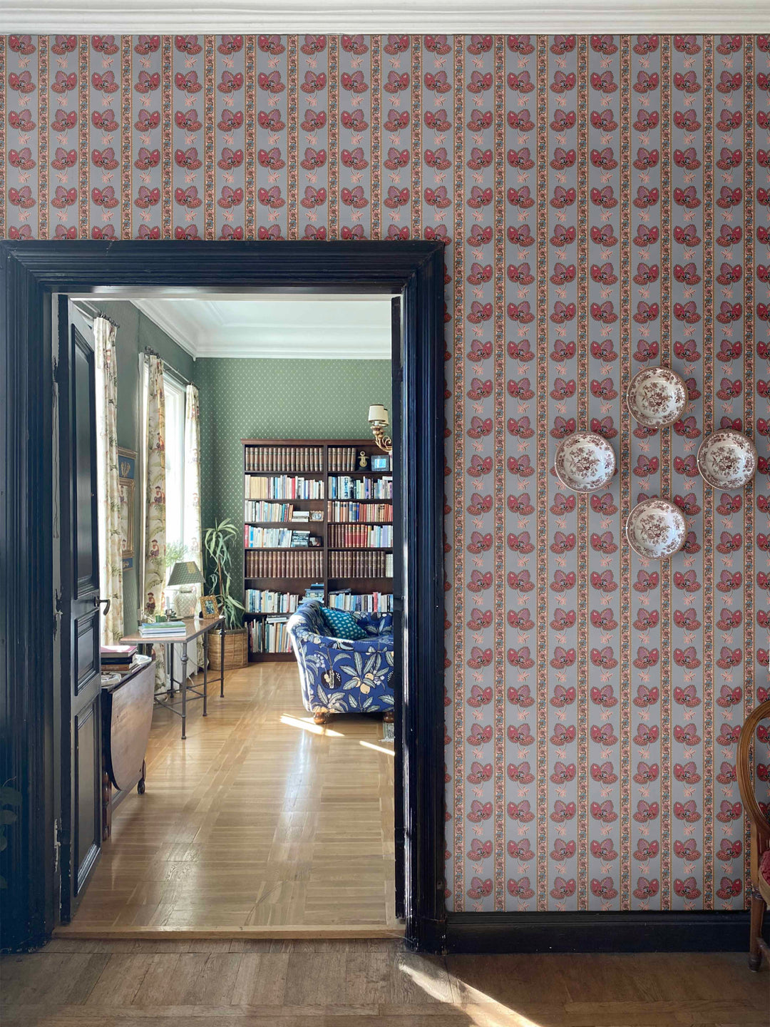 Serafina Stripe wallpaper in a floral striped wallpaper design in dusky blue shown on interior walls