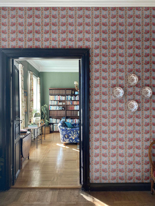 Serafina Stripe wallpaper in a floral striped wallpaper design in dusky blue shown on interior walls