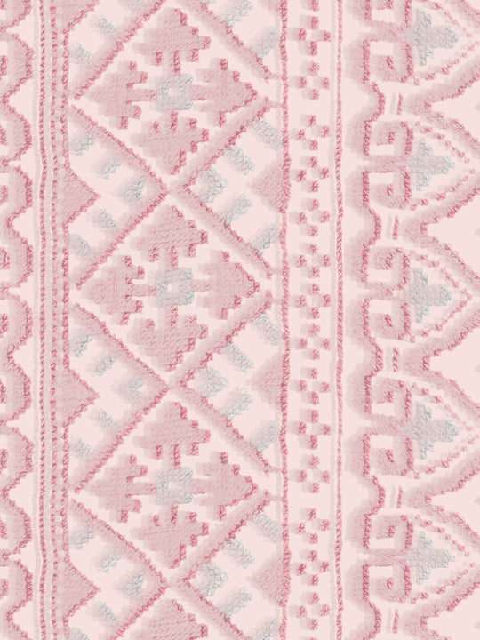 Close-up of a pink and white geometric patterned wallpaper design