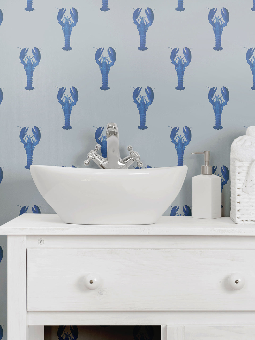 A bathroom decorated with blue lobster wallpaper with a grey background by Milola Design