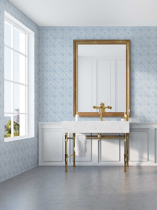A bathroom wallpapered in a pale blue and white coral patterned wallpaper  - Coral Haze by Milola Design