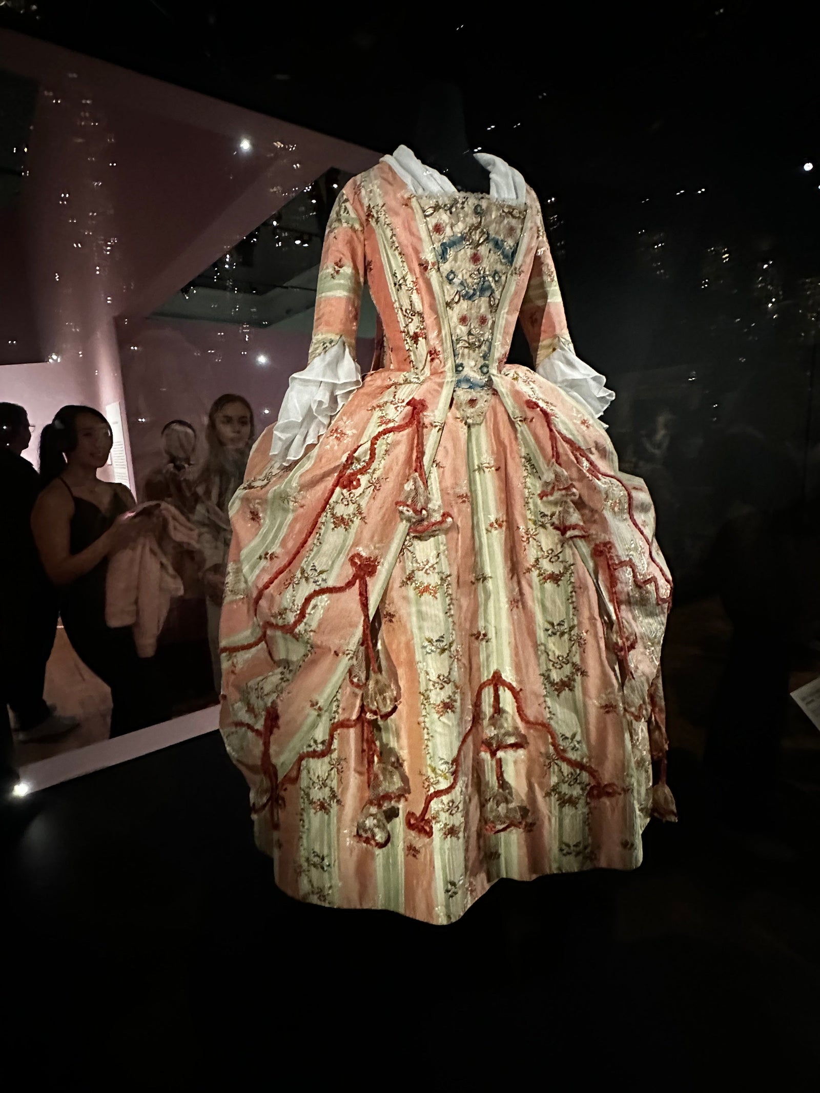 A silk pink and whgite floral striped dress with cord detail from the Marie Antonette Exhibition at V & A