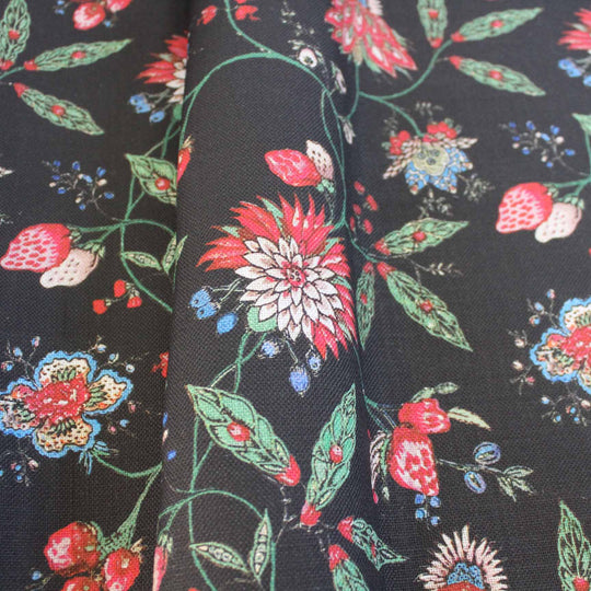 Amalita Floral Fabric featuring vibrant flowers and leaves in pink, green, and blue on a black background, perfect for upholstery.