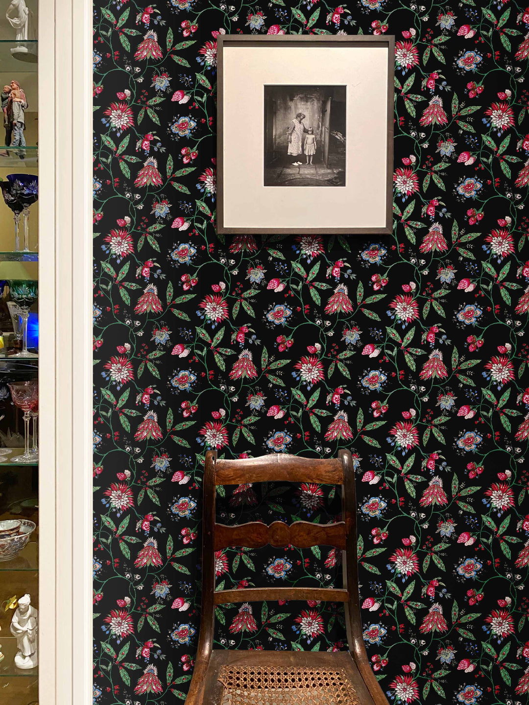 Black wallpaper with pink, green and blue french floral design