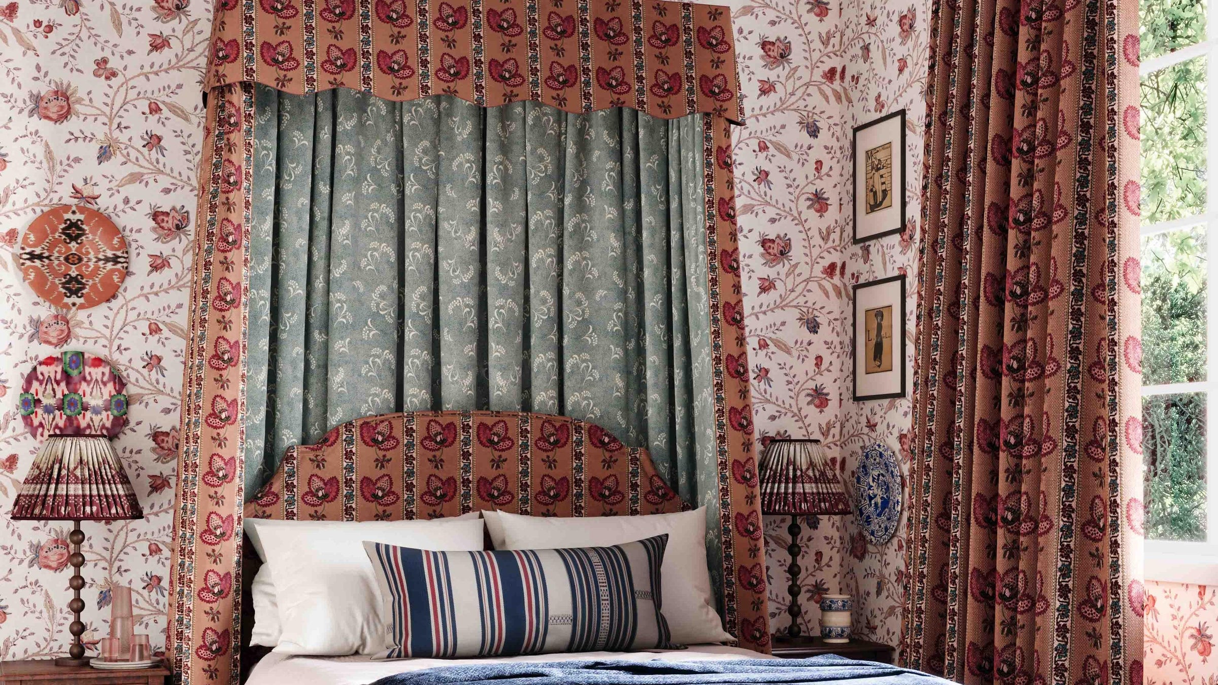 Decorative bedroom with floral wallpaper, curtains, and a bed with striped pillows.
