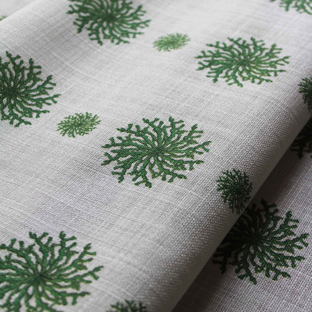 A modern curtain fabric featuring emerald green coral motifs in stripes on a white background by Milola Design