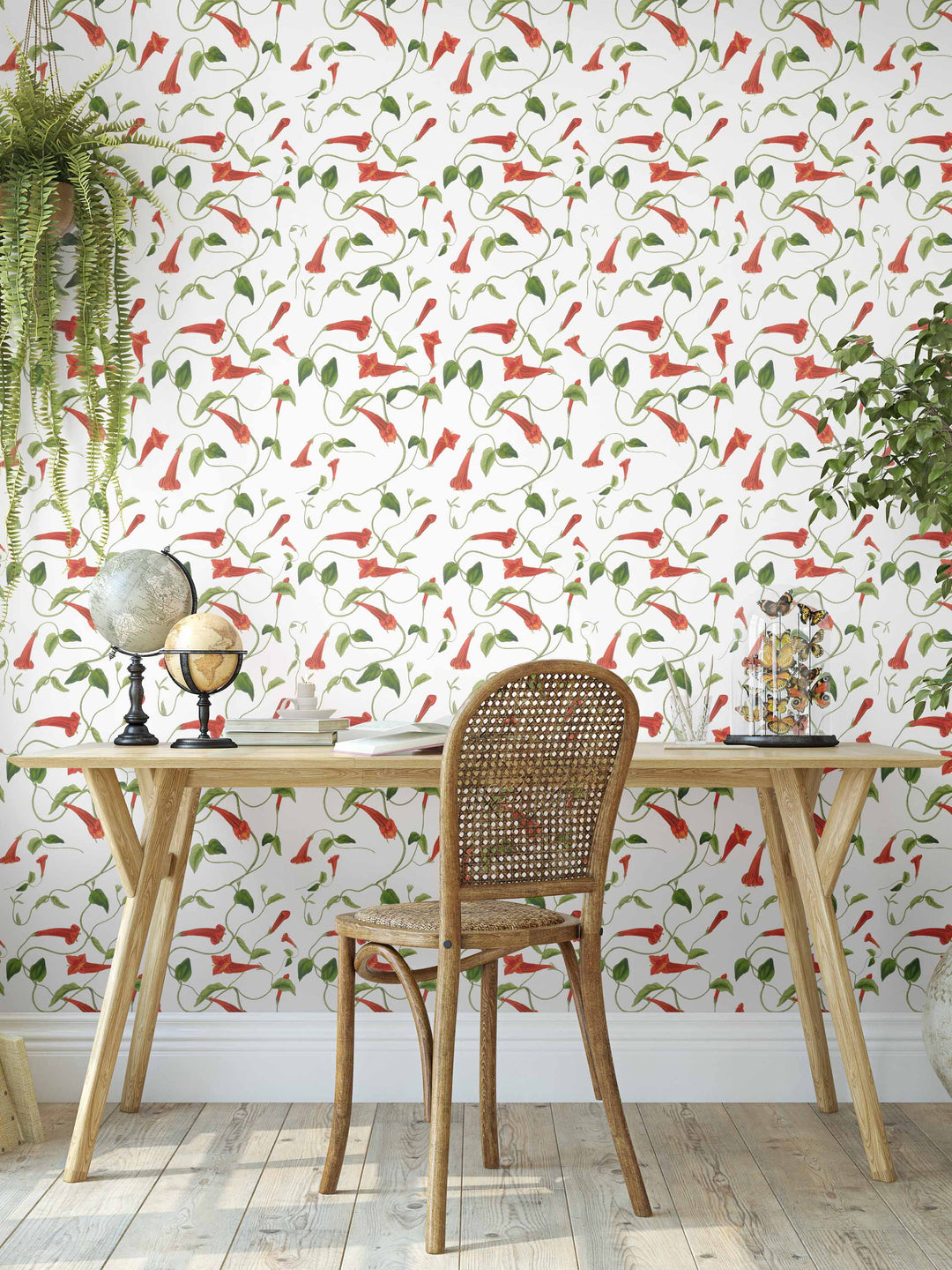 An interior with a red and green trailing floral wallpaper featuring fed firecraker flowers and leaves. resulting in a fresh, yet warm interior design.