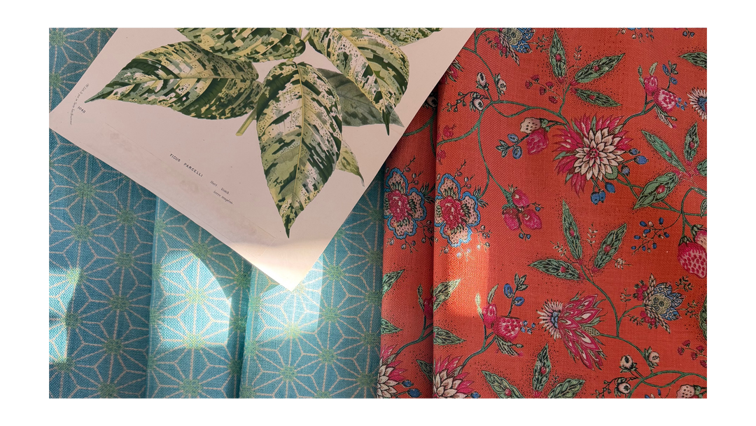 Two fabric swatches, one with a green leaf pattern and the other with a floral pattern on an orange background.