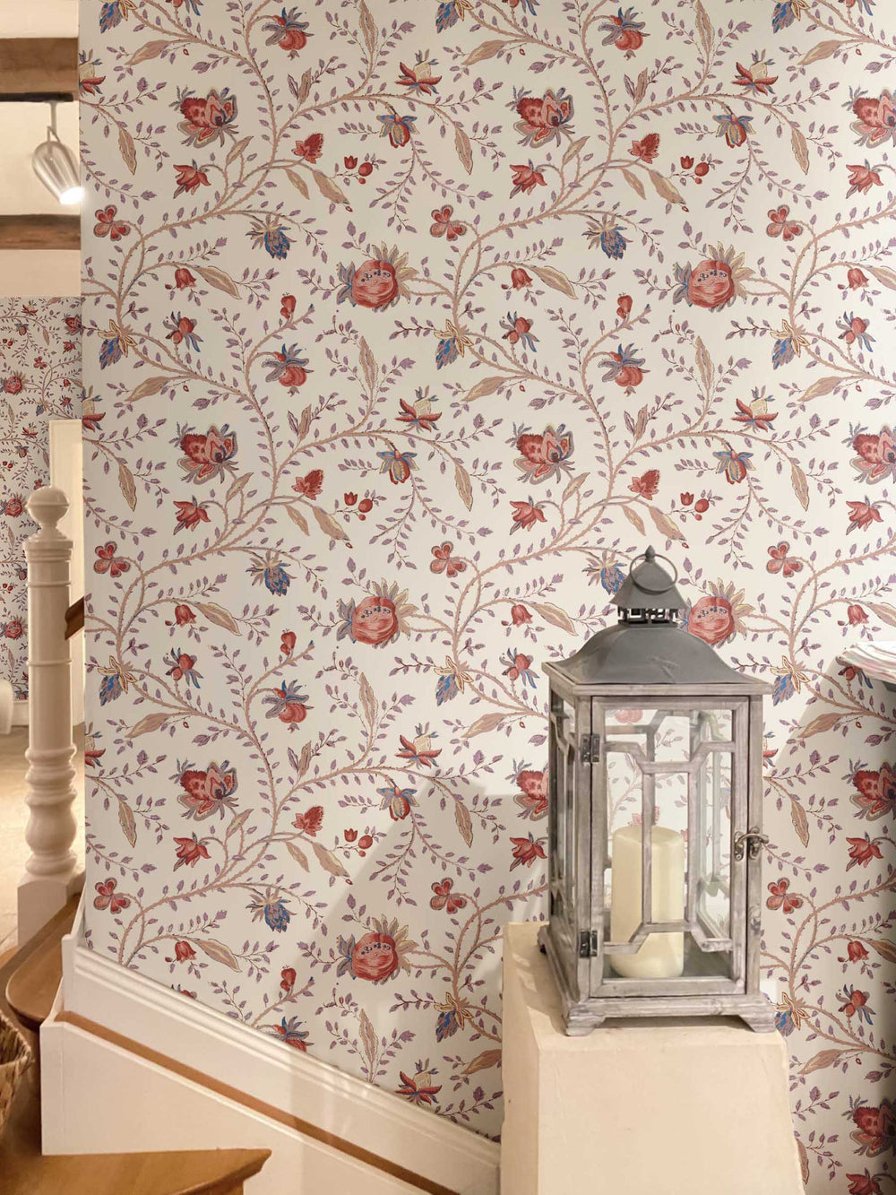A hallway decorated in a heritage floral wallpaper design in peachy earthy tones.
