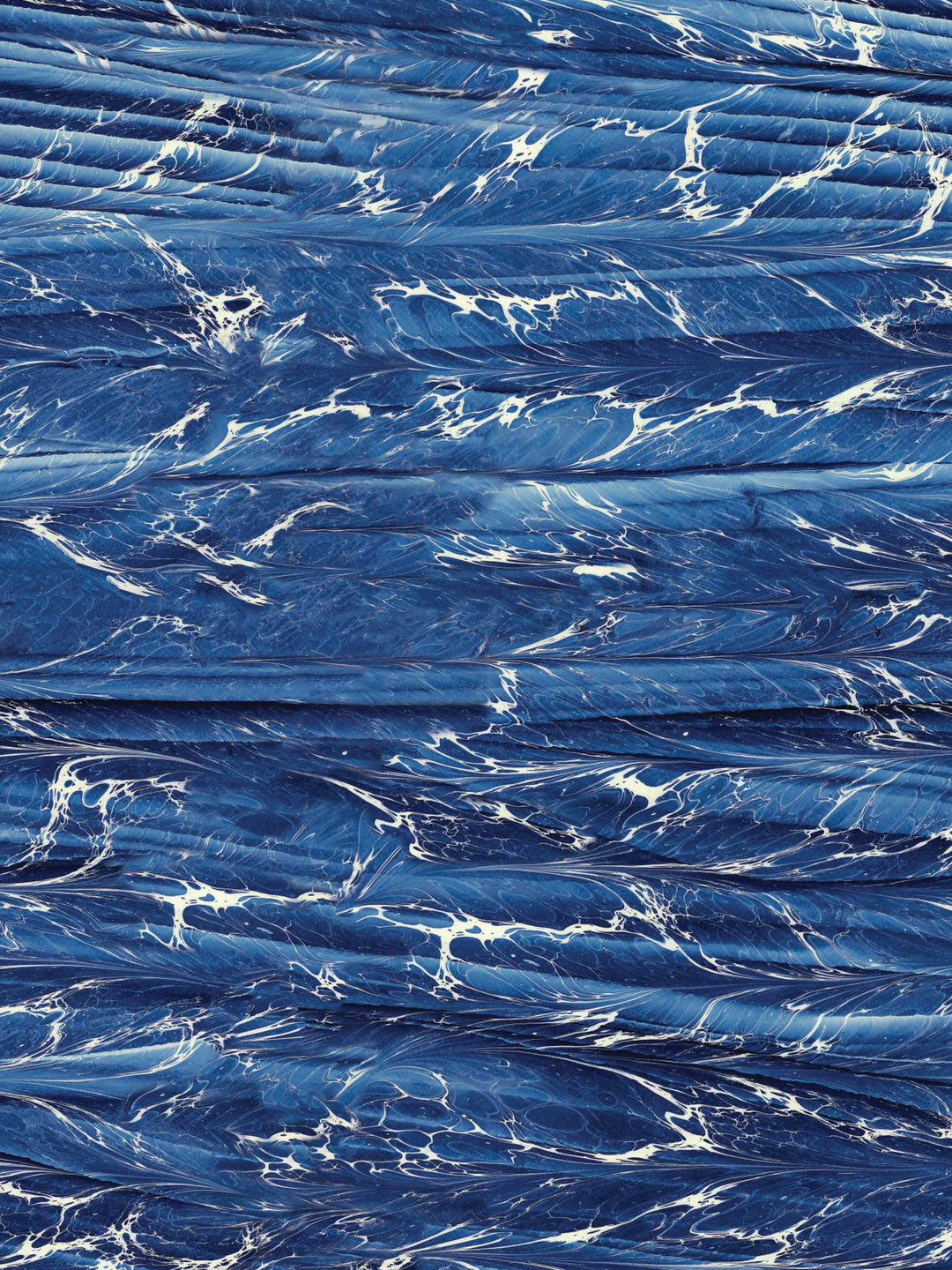 Close-up of a home wallpaper design with blue marbled texture with white veins