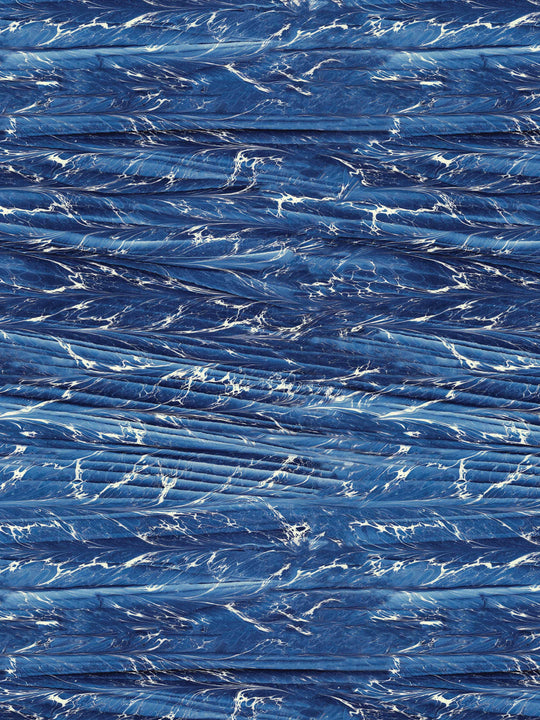 A dark blue marbled wallpaper design 