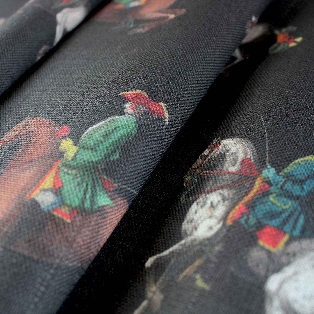 A black statement linen mix fabric printed with 17th Century horse riders in colourful period clothes by Milola Design. This fabric is suitable for curtains, blinds and soft furnishings.