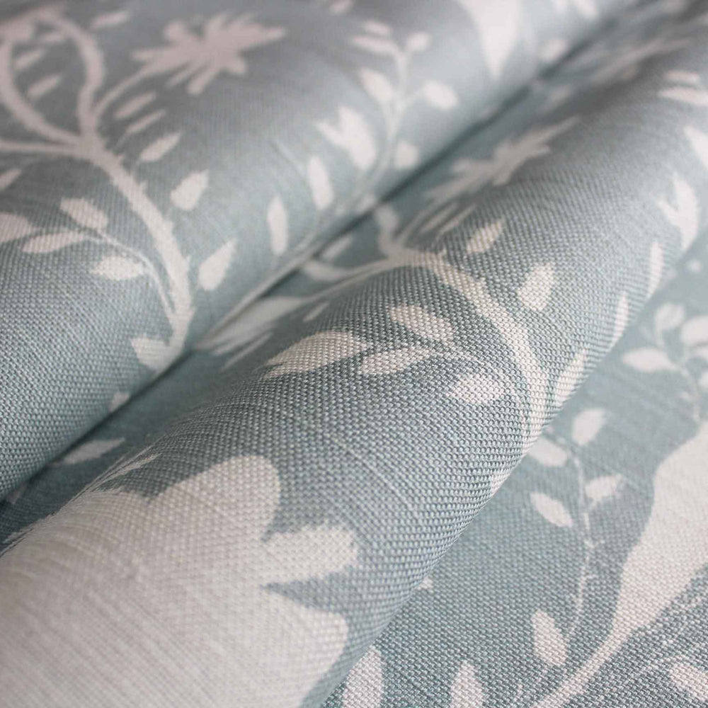 A product image of pale blue and white floral fabric for curtains, blinds and soft furnishings by Milola Design