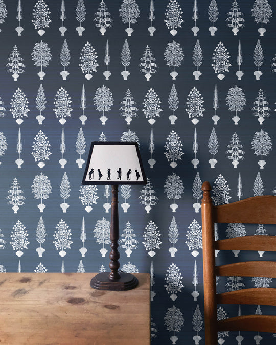 Spirt palms wallpaper decorating a wall with a white ornate trees pattern on a dark blue background