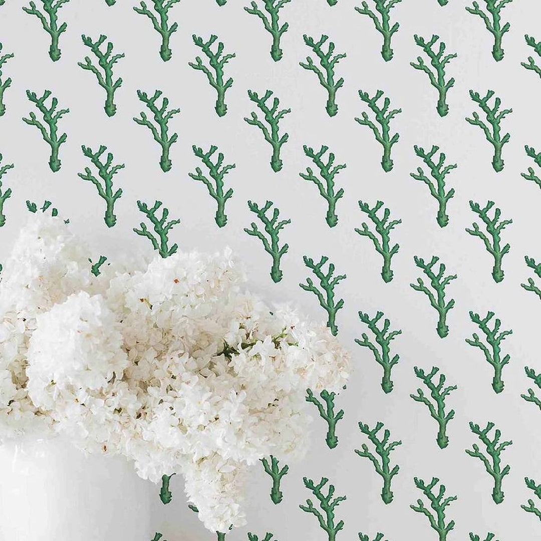 Coral Dash wallpaper in emerald green, flat lay of the repeating coral pattern