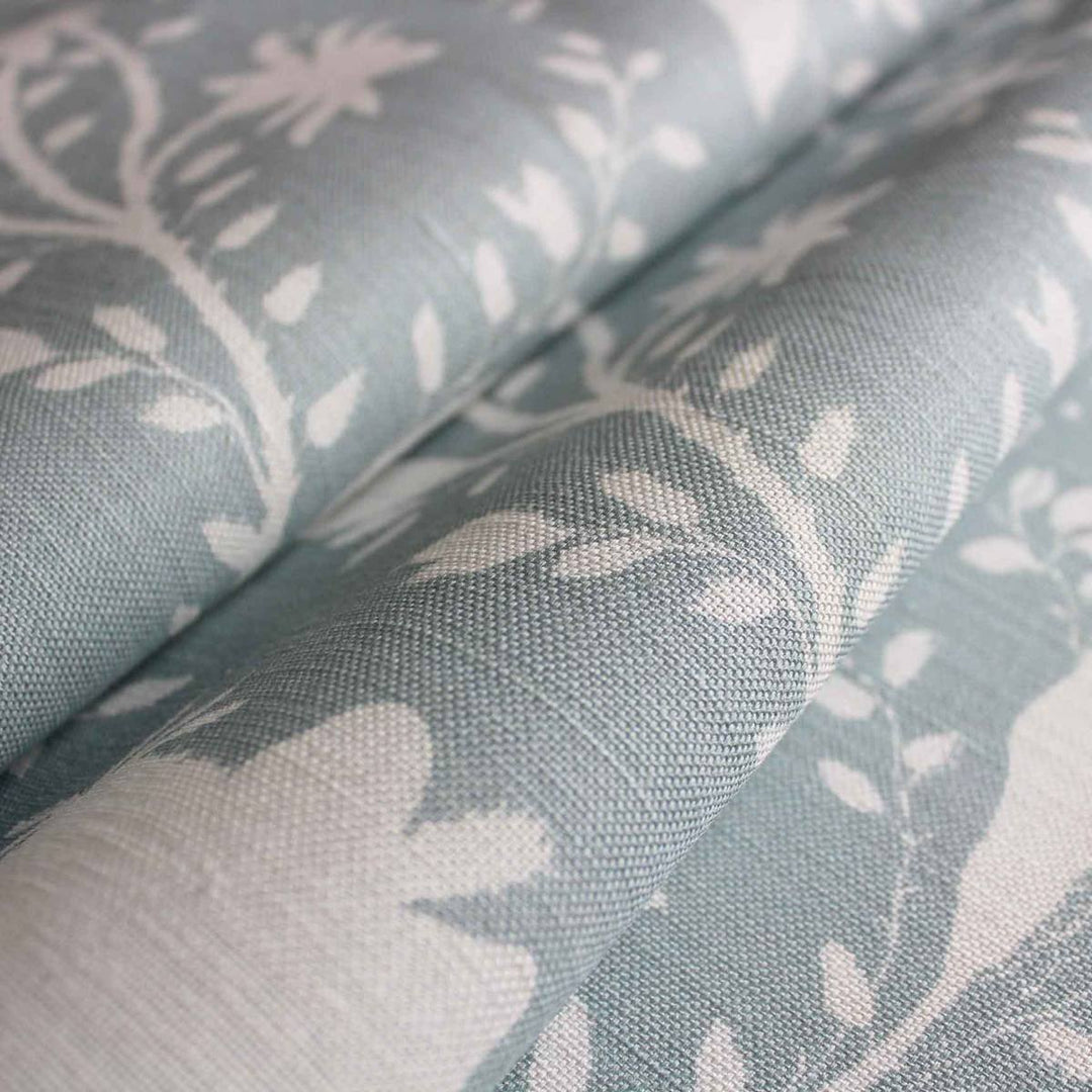 A product image of pale blue and white floral fabric for curtains, blinds and soft furnishings by Milola Design