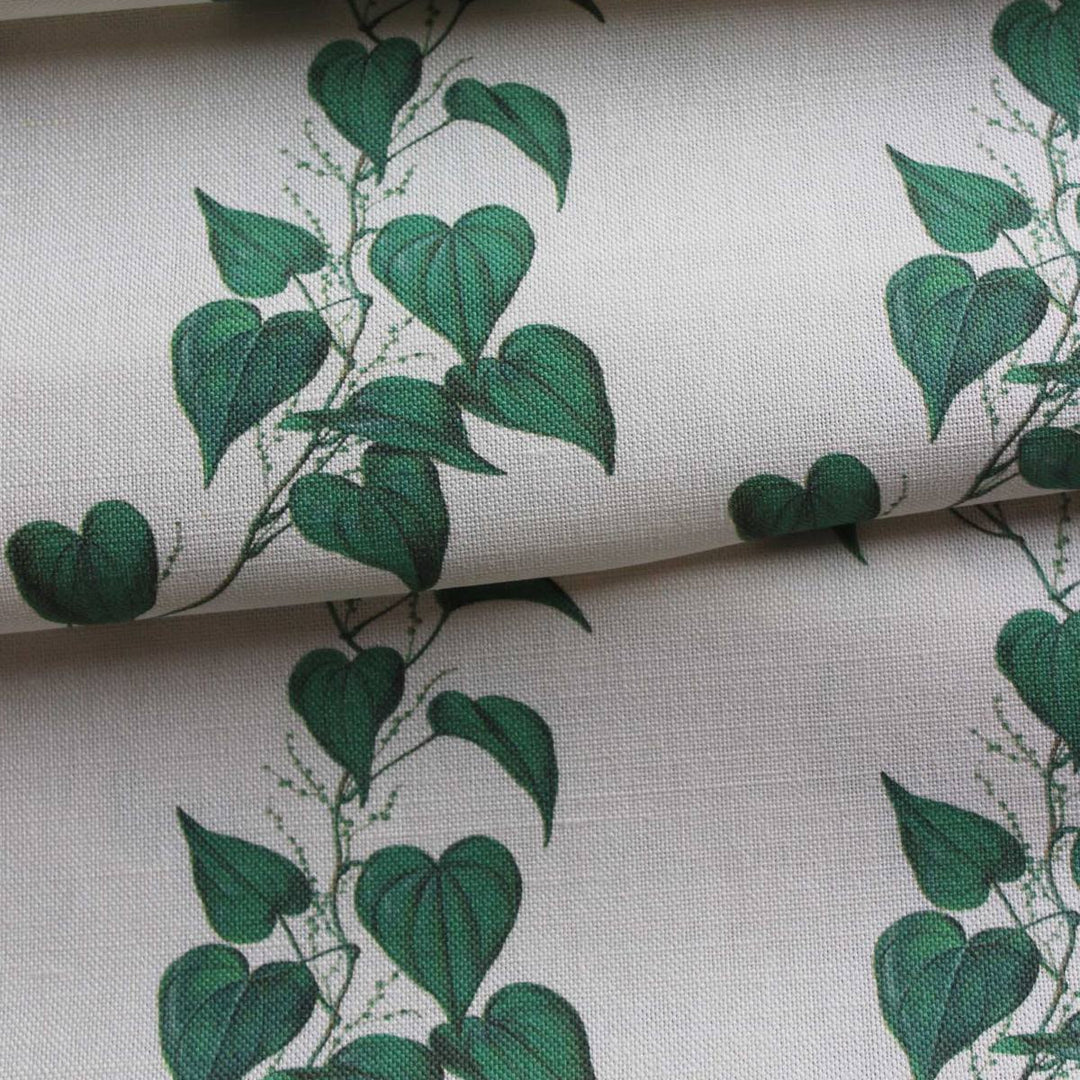 Linen curtain fabric featuring trailng green vine leaves on a off white background by Milola Design.