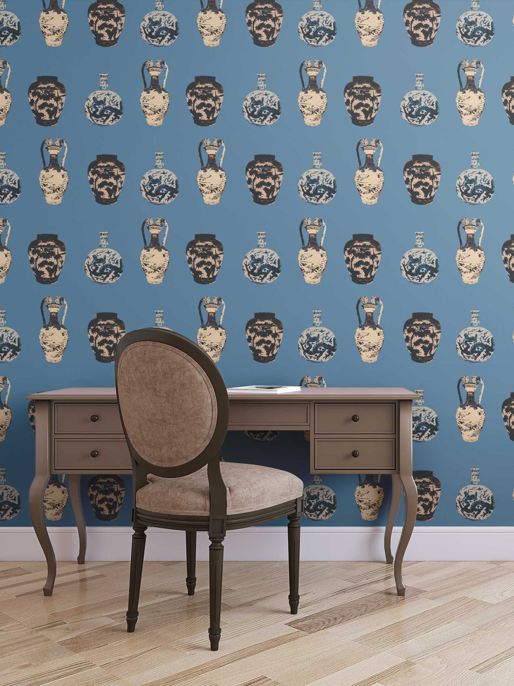A room with a blue wallpaper featuring a pattern of antique Chinese vases, with a wooden desk and chair in the foreground.