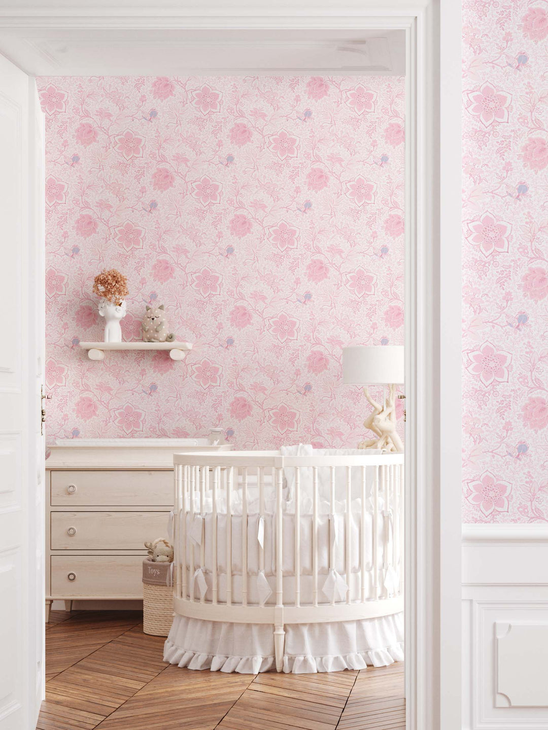 Baby's nursery with a pretty pink floral wallpaper and white nursery furniture. Wallpaper by Milola Design