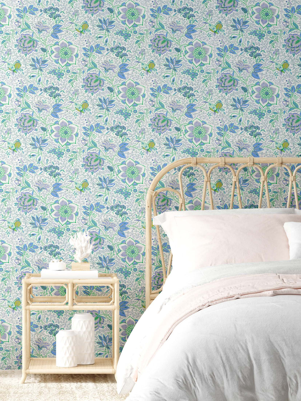 A vintage inspired mint blue green floral wallpaper on the walls of a bedroom with wicker bed and table