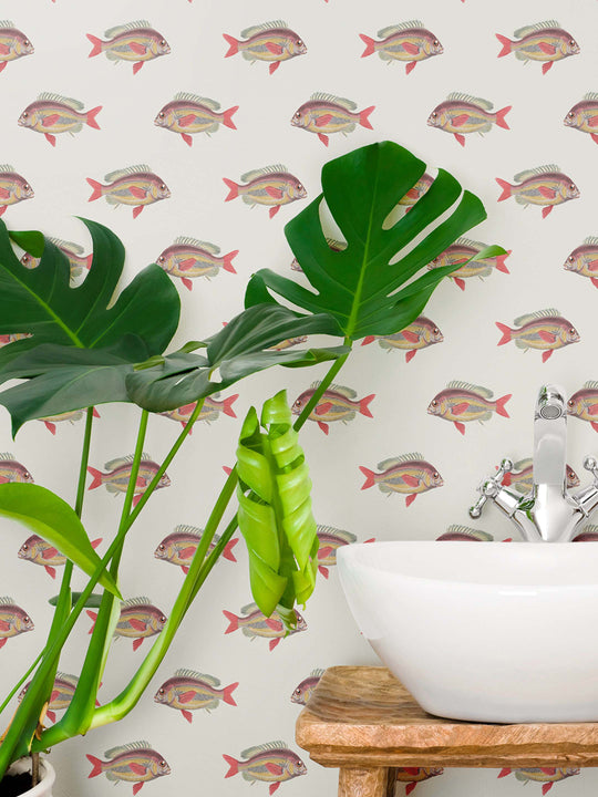 An elegant fish wallpaper design on a cream background elevating this coastal style bathroom walls
