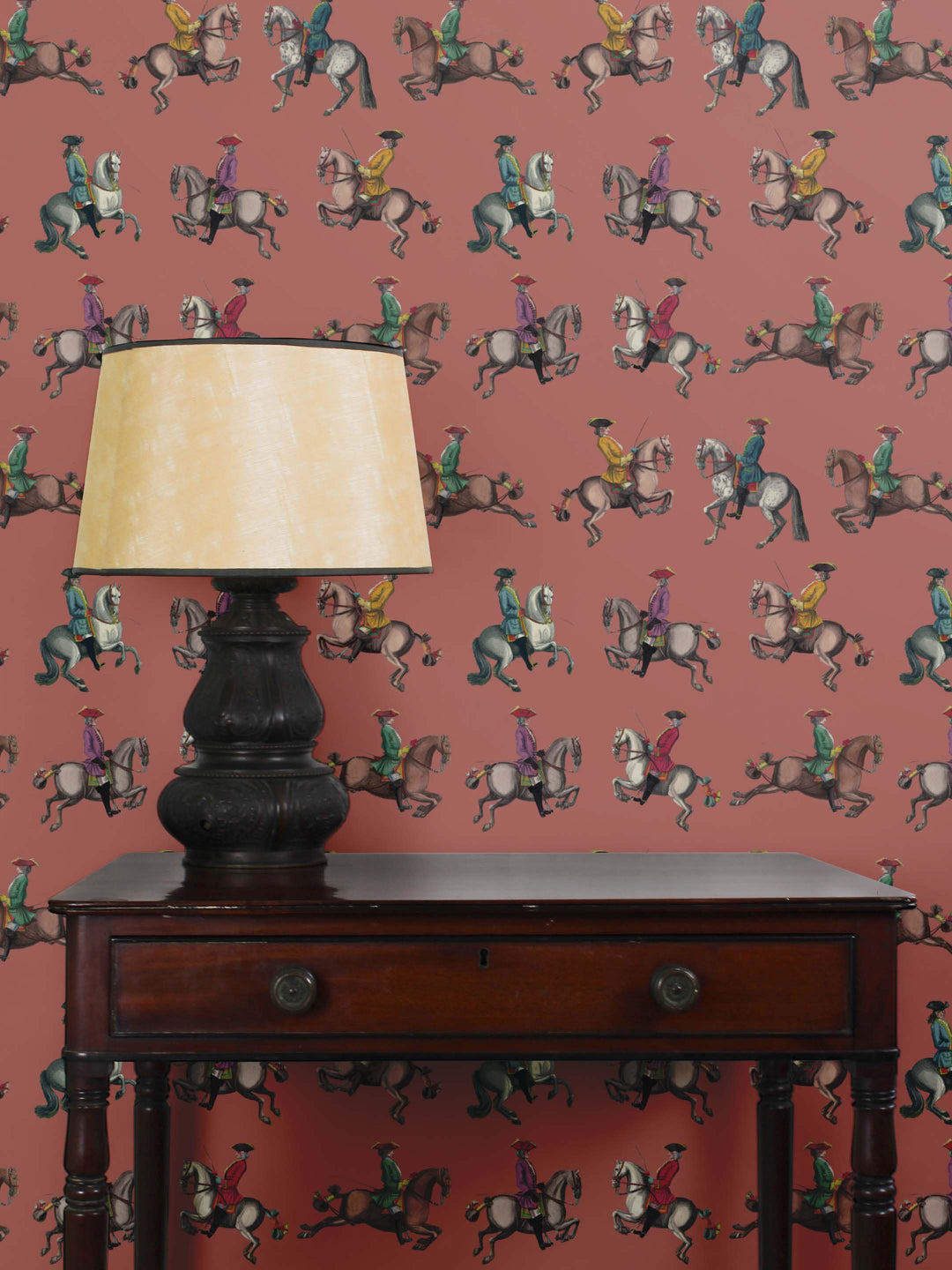 Statement wallpaper featuring horse riders from the 1700's on a sienna background