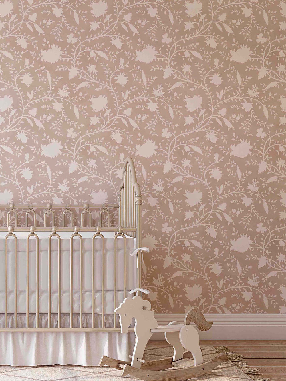 nursery with pale pink and white elegant floral wallpaper on the walls